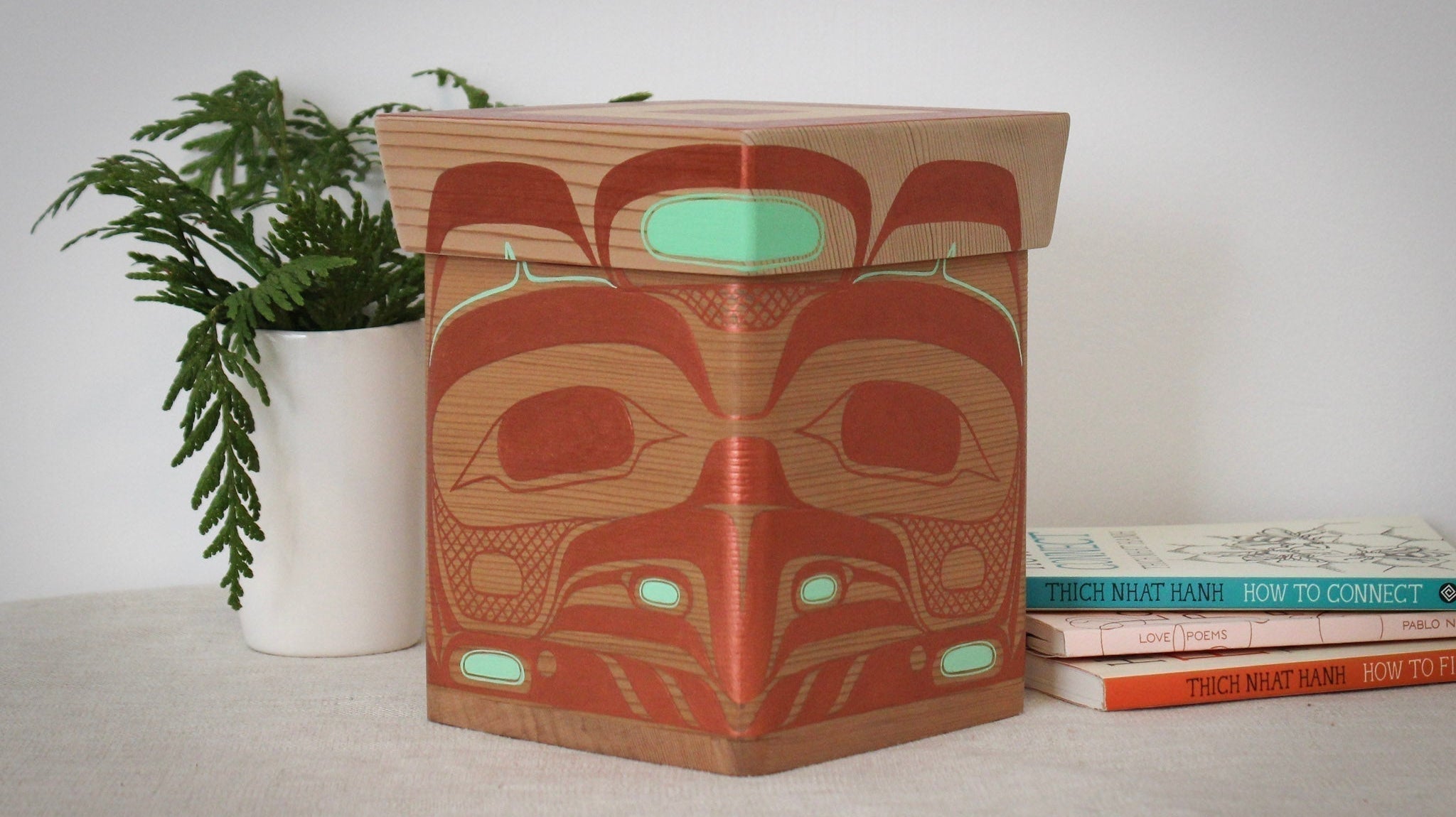 Eagle design painted onto a wooden box placed on a table