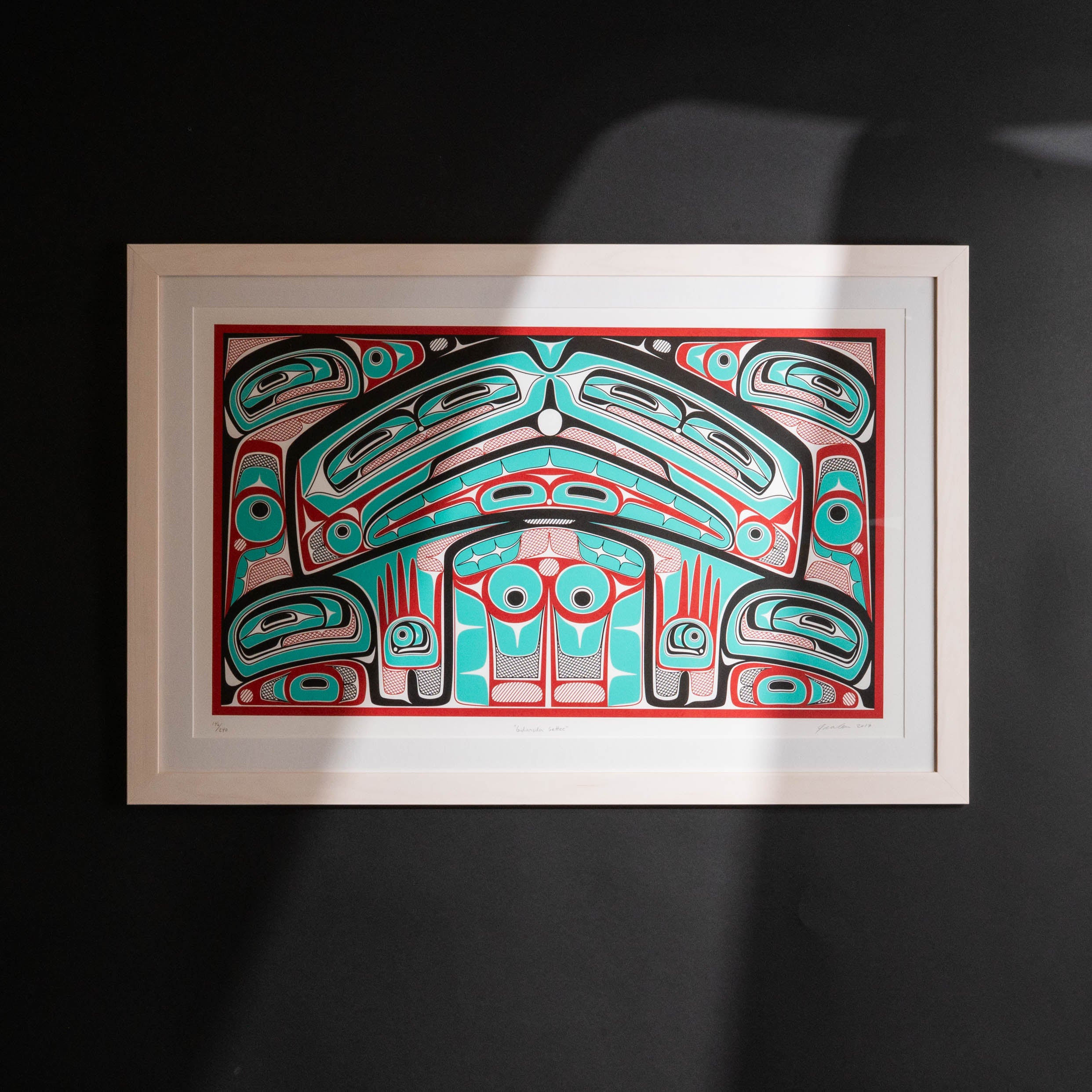 Colorful abstract formline chiefs chair design with geometric haida patterns framed on a dark background