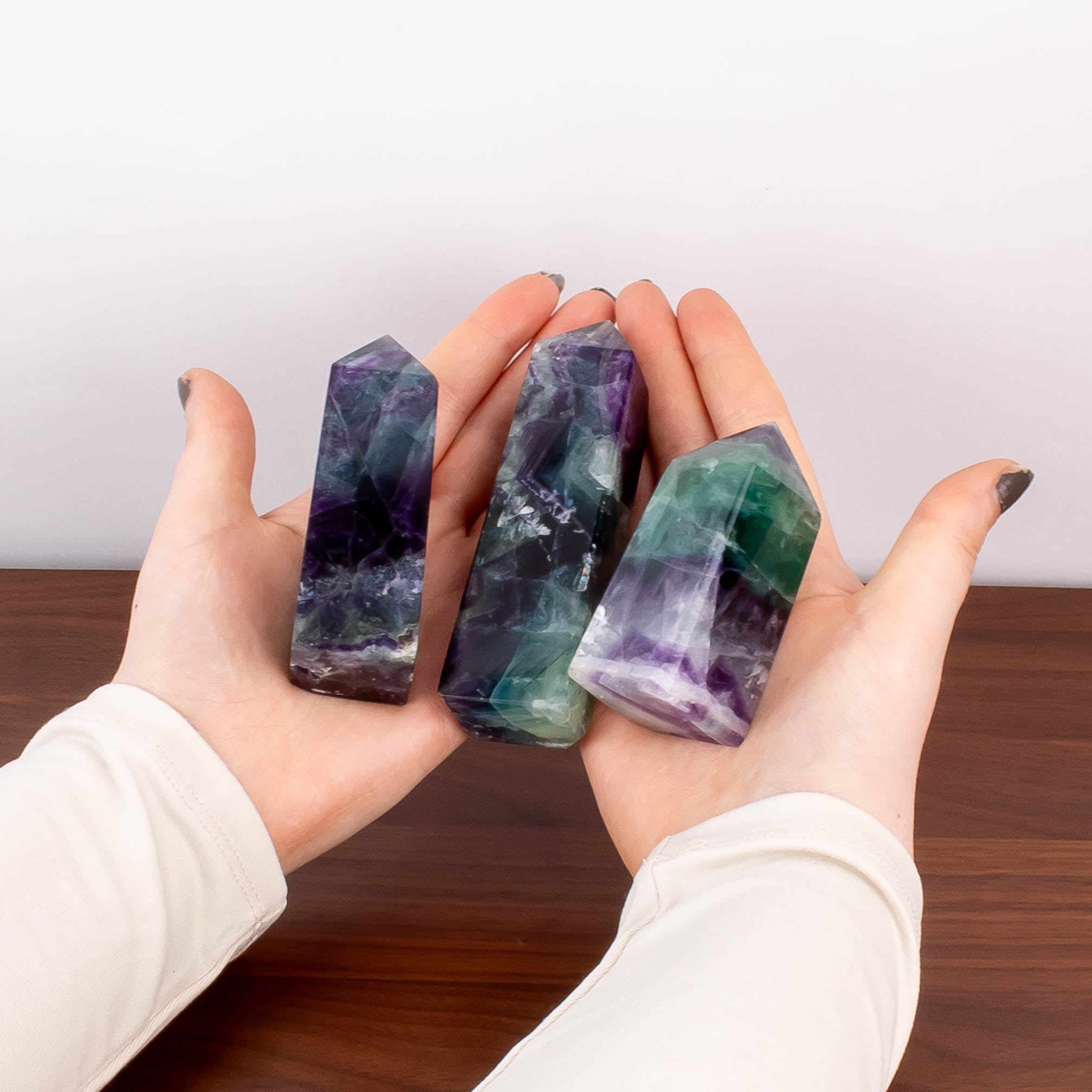 Hands holding fluorite crystals.