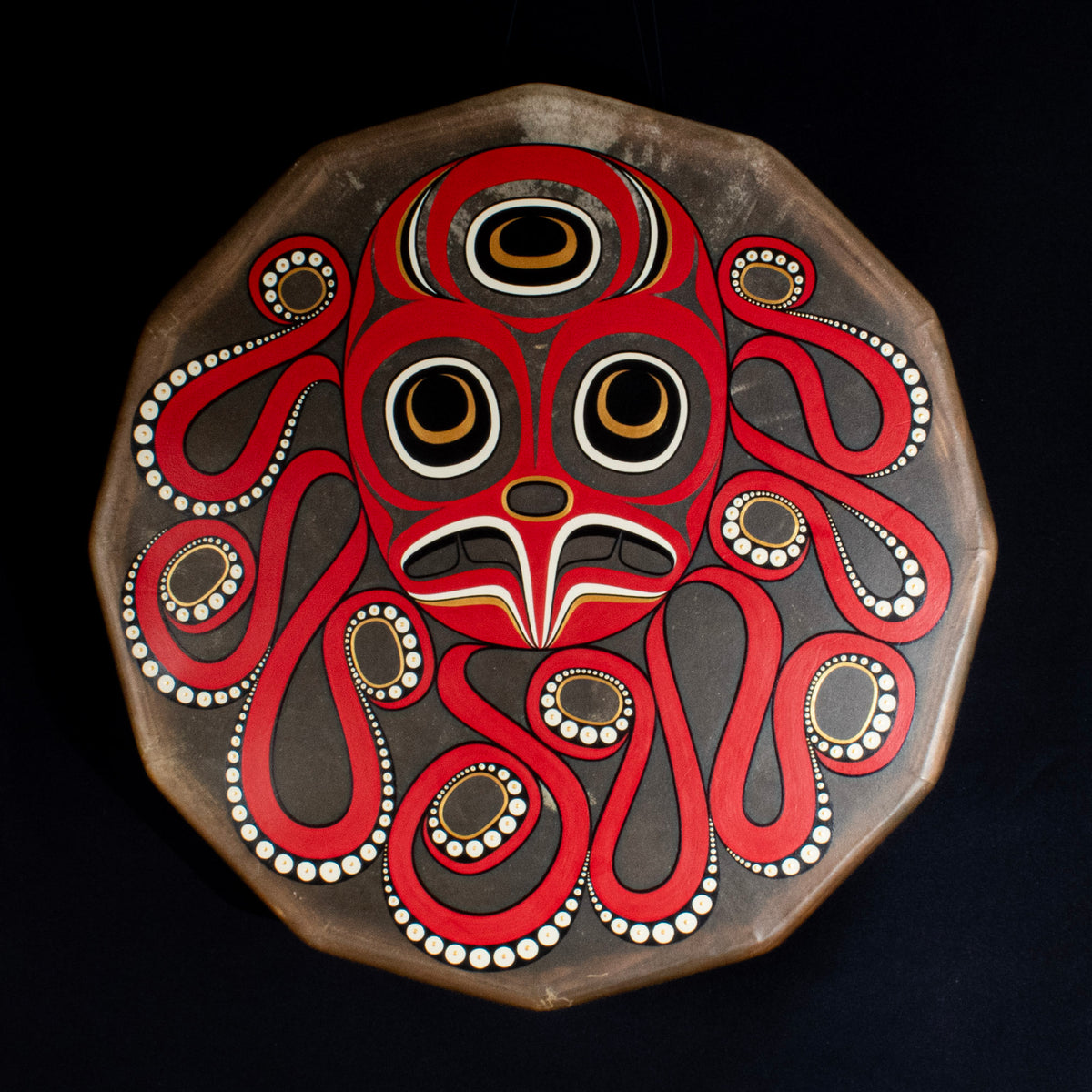 A painting of an octopus design on a deer hide drum