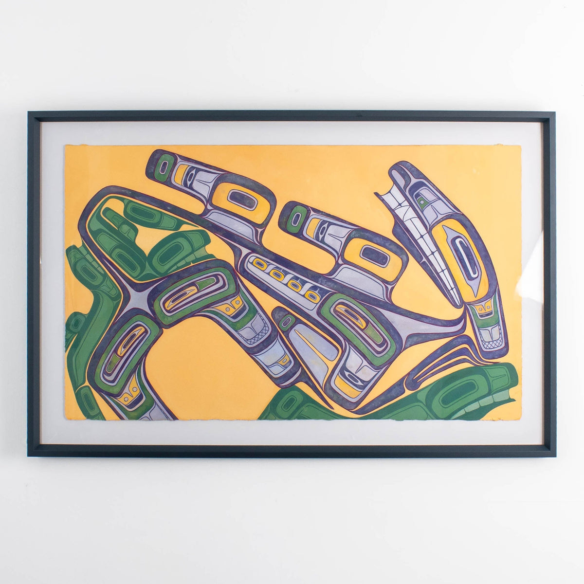 Framed abstract Formline wasco artwork with geometric shapes on a yellow background framed with conservation glass