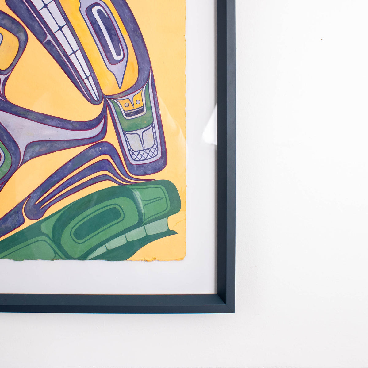 Framed abstract artwork with colorful design on a yellow background