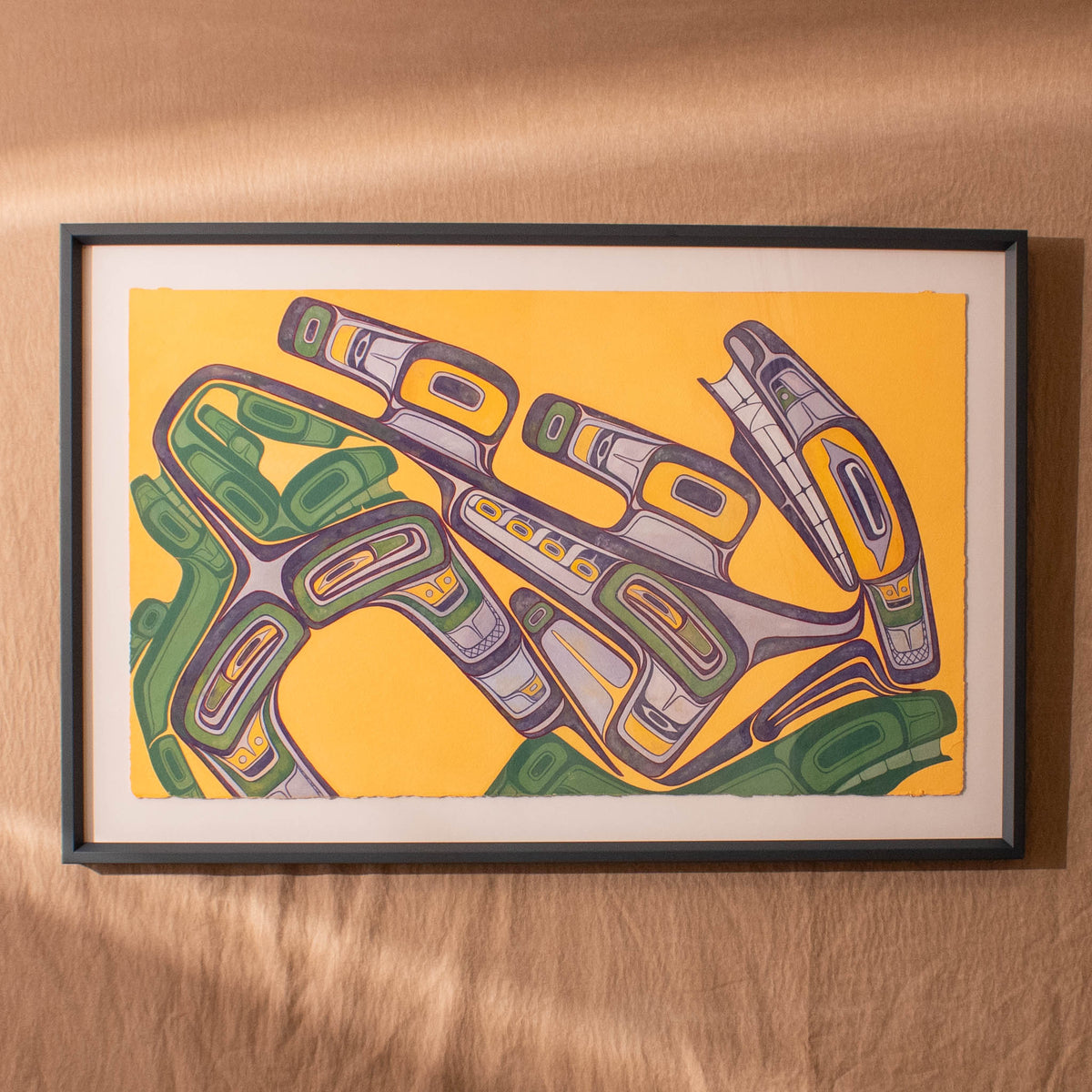 Framed abstract artwork with green, purple, and gray elements on a yellow background