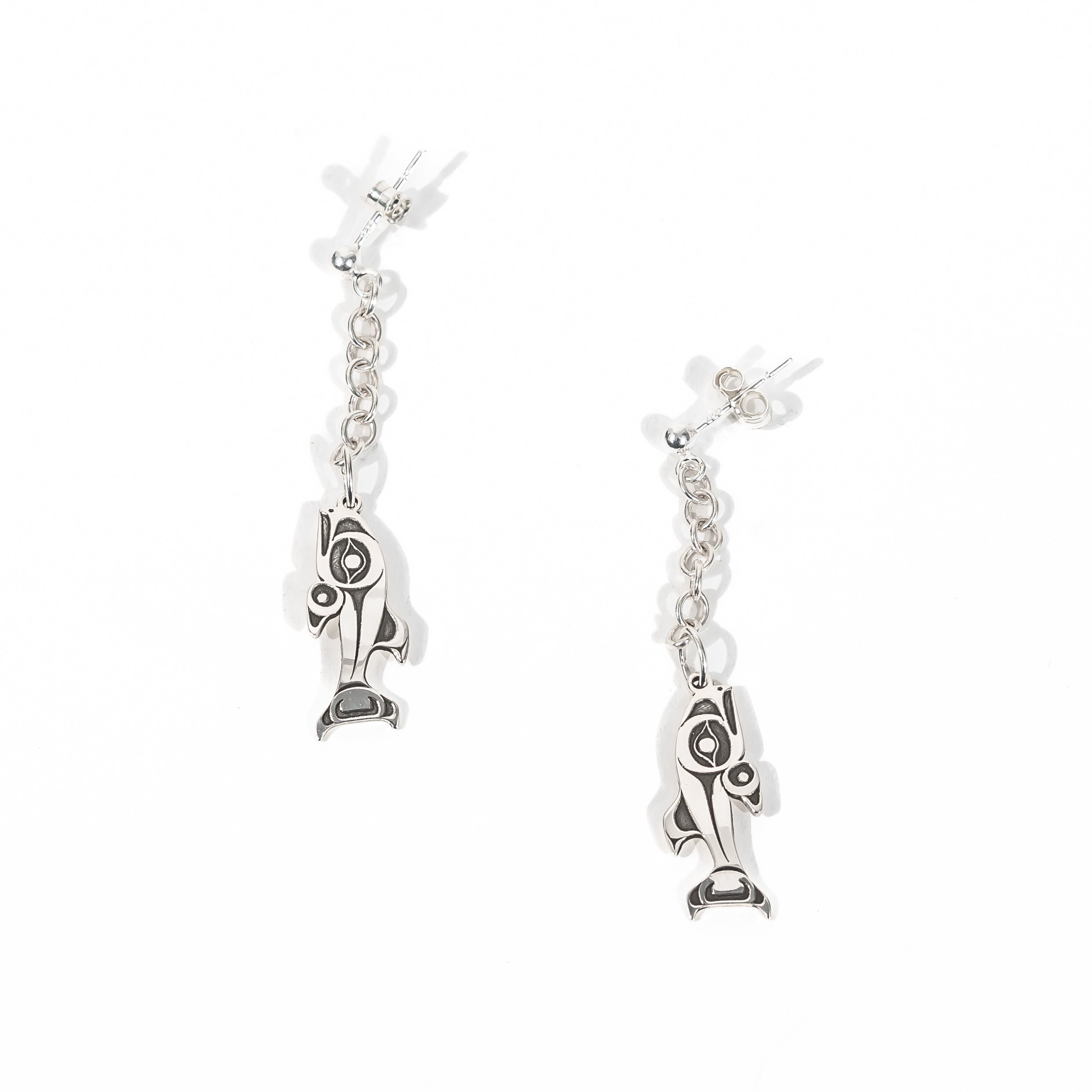 Sterling Silver Stud Earrings with chain dangles and a NOrthwest Coast style salmon charm on a white back ground by Ts'msyen artist Morgan Asoyuf