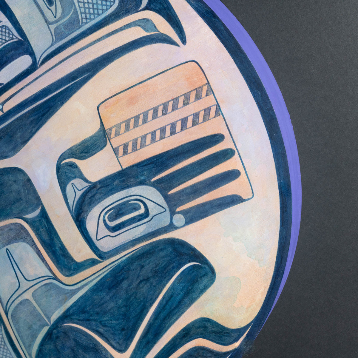 Close up of painted wood with blue hand holding orange basket.