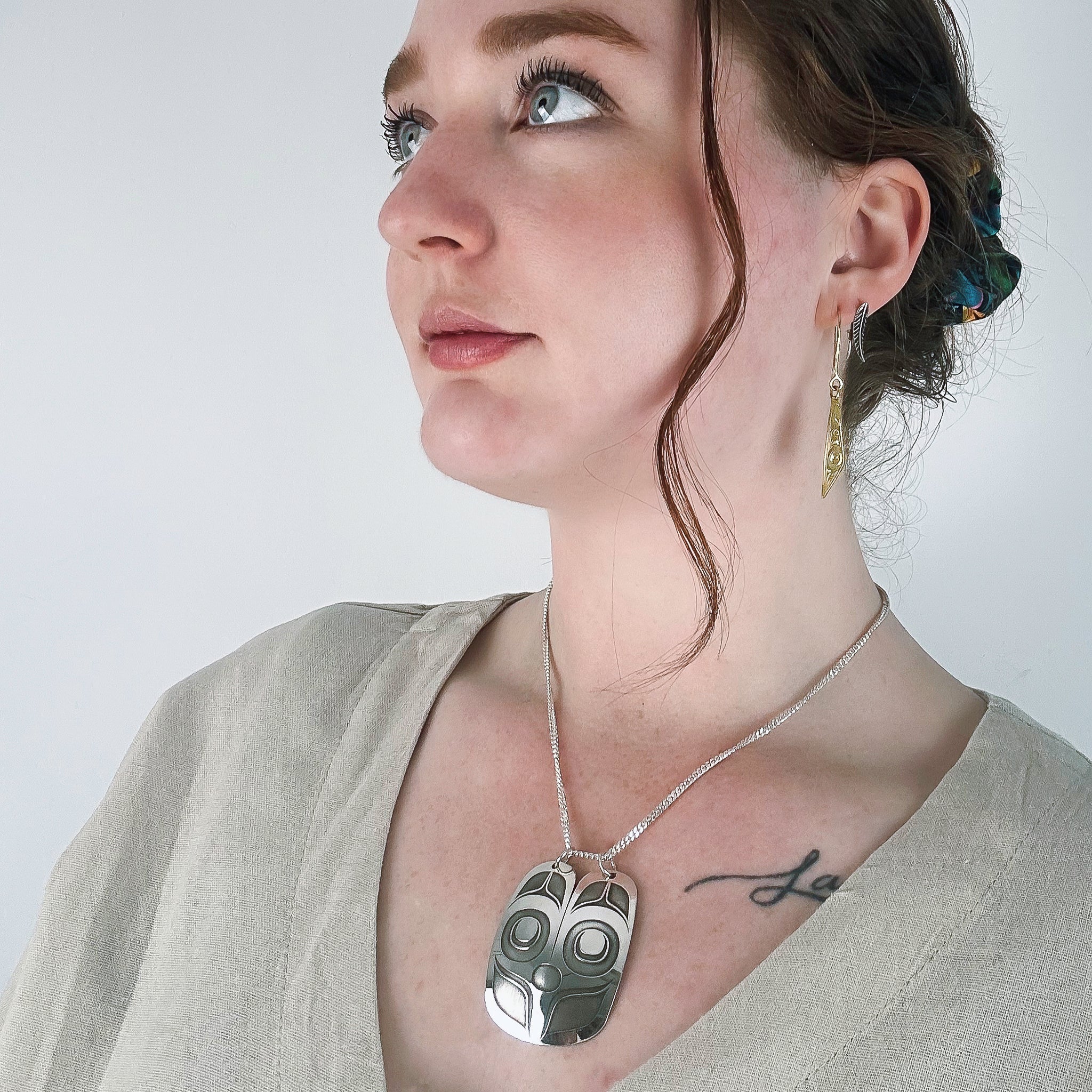 Sterling Silver Mouse Woman Pendant, by Danika Saunders Nuxalk artist and jeweller, worn by model life style photo