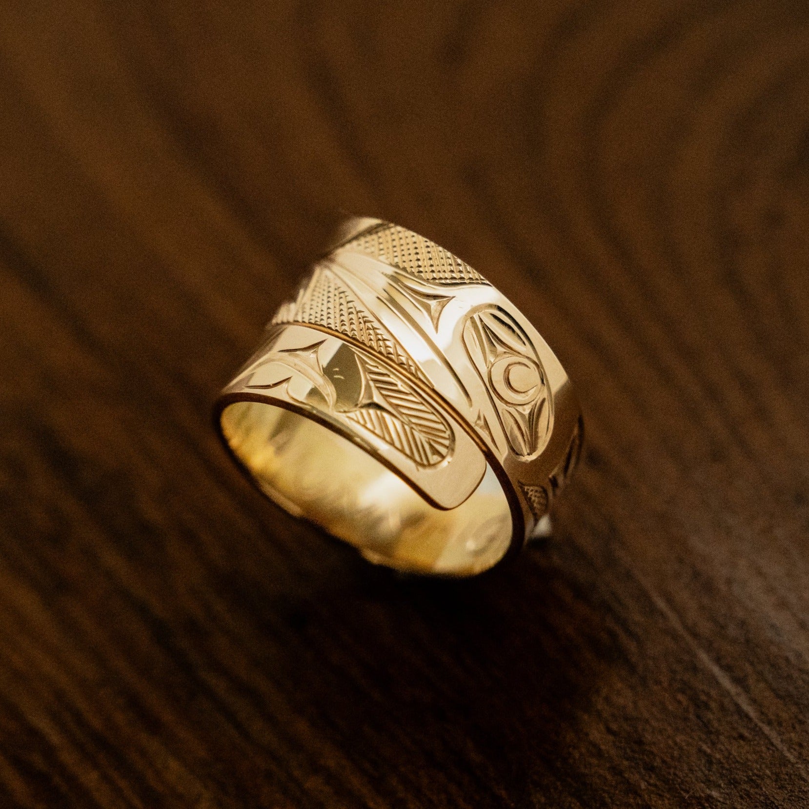 Picture of a Haida Ring in gold by James Sawyer featuring a hummingbird pattern