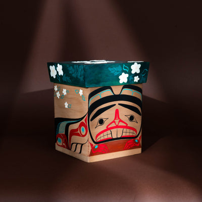 Decorative wooden box with artistic design on a dark background