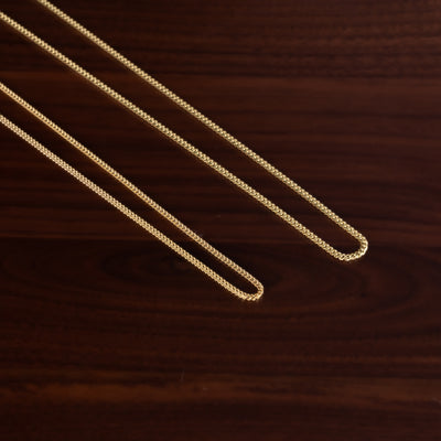 Gold chain on a wooden surface