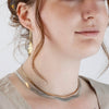 Close up of woman modelling 18K gold mouse woman earrings by Morgan Asoyuf
