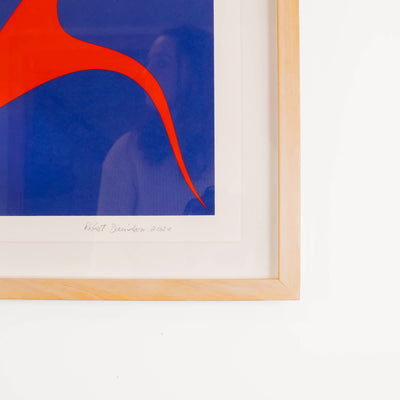 Framed abstract artwork with red and blue design on a white background