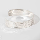Hand carved sterling silver Eagle bracelet by Haida artist Alvin Adkins side view