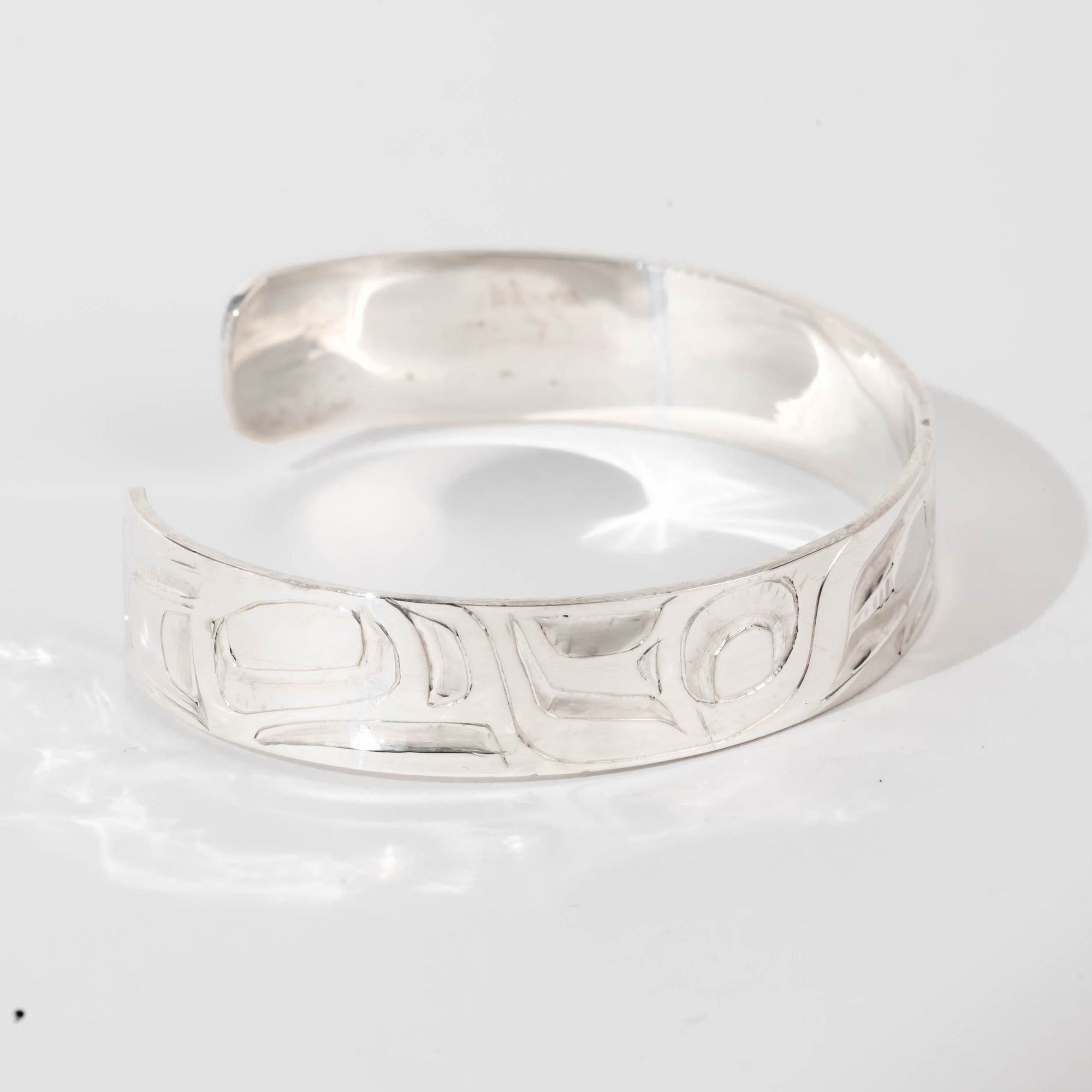 Hand carved sterling silver Eagle bracelet by Haida artist Alvin Adkins side view