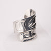 Silver ring with intricate design on a white background