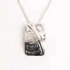 Silver hand carved hummingbird pendant necklace on a white background