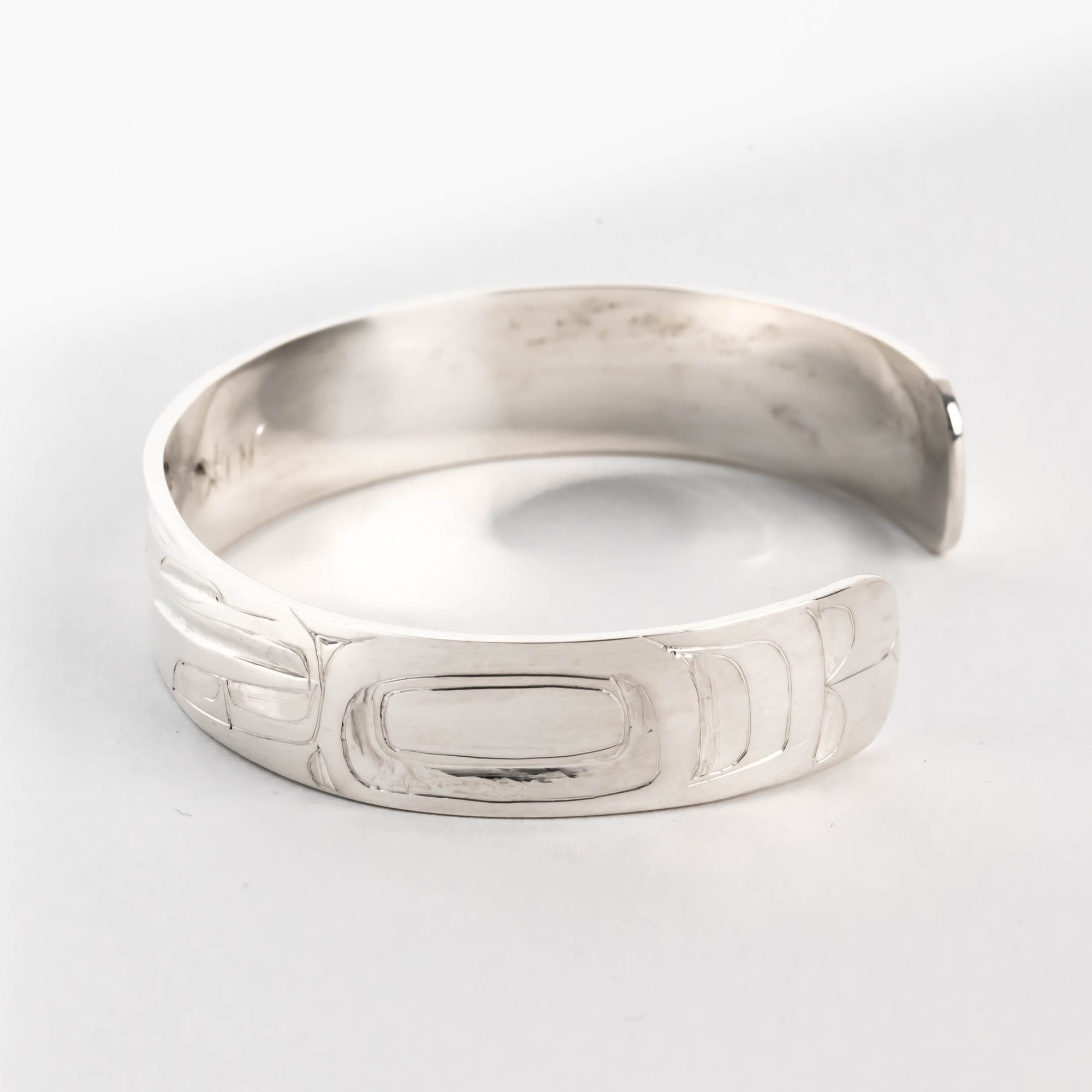 Hand carved sterling silver hummingbird bracelet by Haida artist Alvin Adkins side view