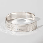 Hand carved sterling silver Raven bracelet by Haida artist Alvin Adkins side view