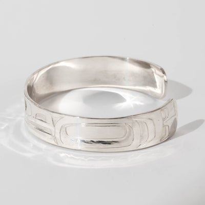 Hand carved sterling silver Raven bracelet by Haida artist Alvin Adkins side view