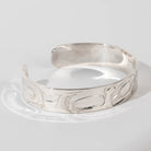 Hand carved sterling silver Orca bracelet by Haida artist Alvin Adkins side view