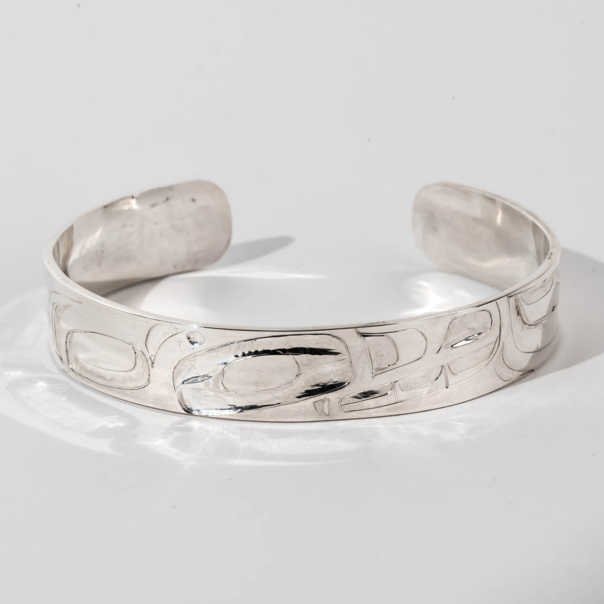 Hand carved sterling silver Orca bracelet by Haida artist Alvin Adkins front view