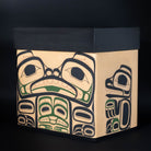 Front of Haida bentwood box showcasing Bear mother in haida formline painting and mouse woman tucked below her, her cub on the right hand side of the box on a black background