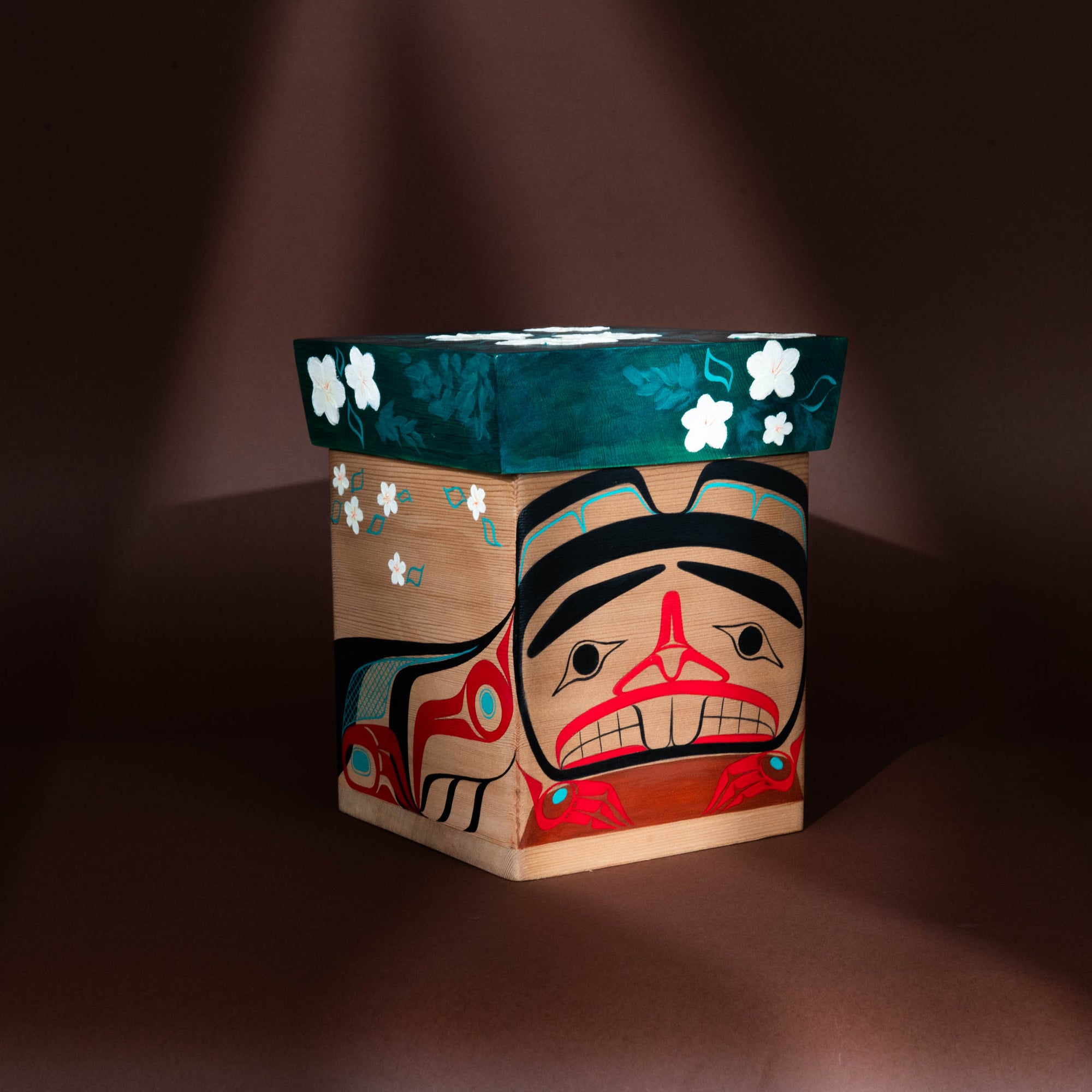 Wooden box with artistic face design on a dark background