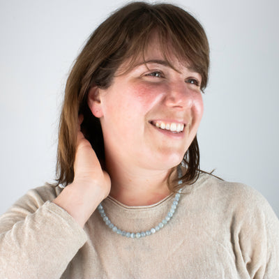 Locally made blue topaz hand beaded necklace worn by model