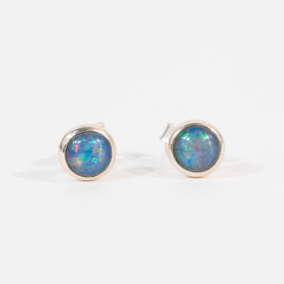 Pair of opal stud earrings on a white background