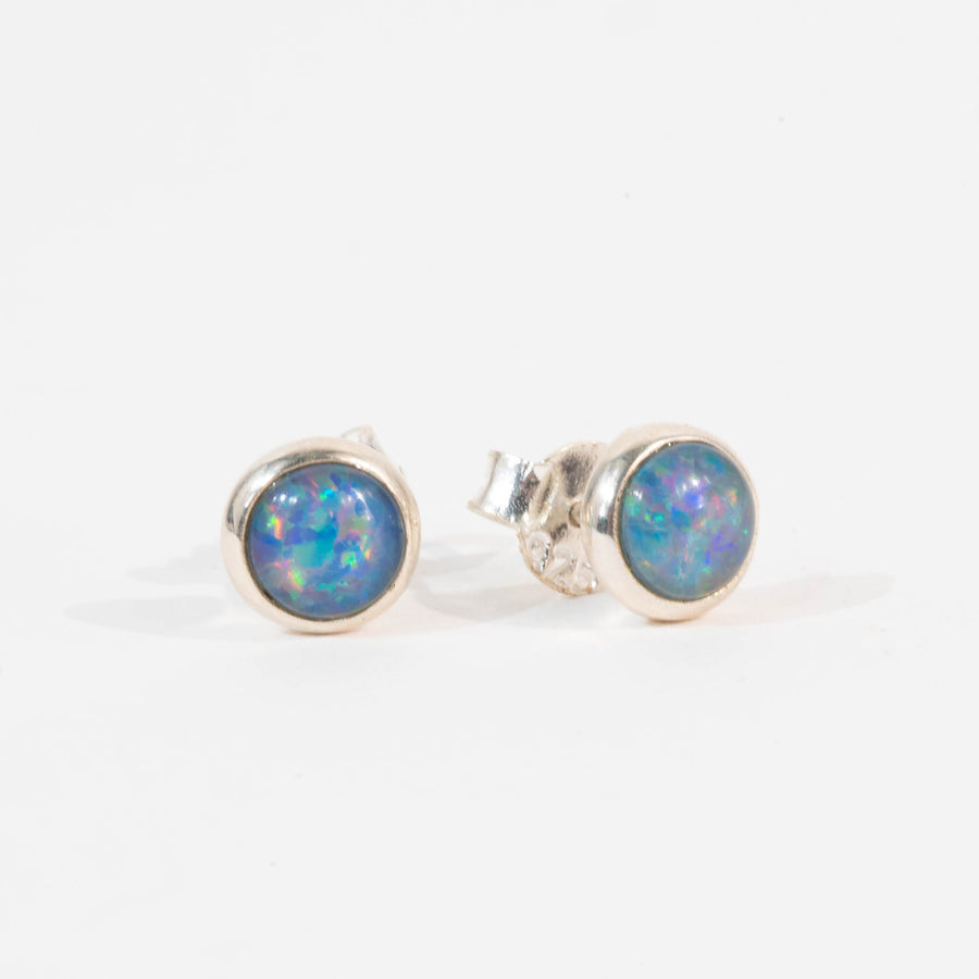 Pair of silver opal stud earrings on a white background