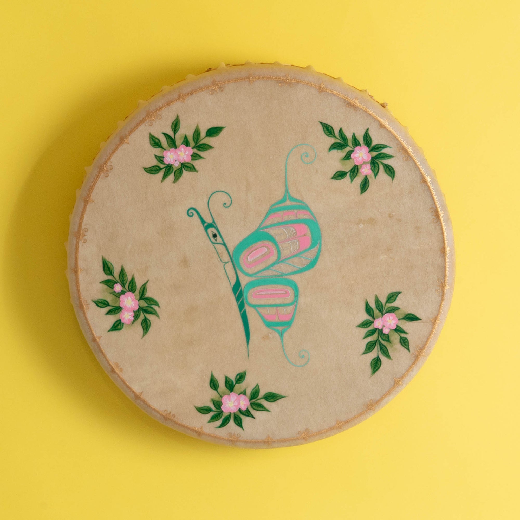 Butterfly Haida Art Drum by Danielle Louise Allard on a yellow background.
