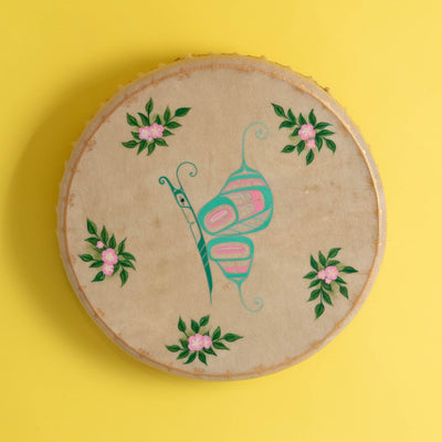 Butterfly Haida Art Drum by Danielle Louise Allard on a yellow background.