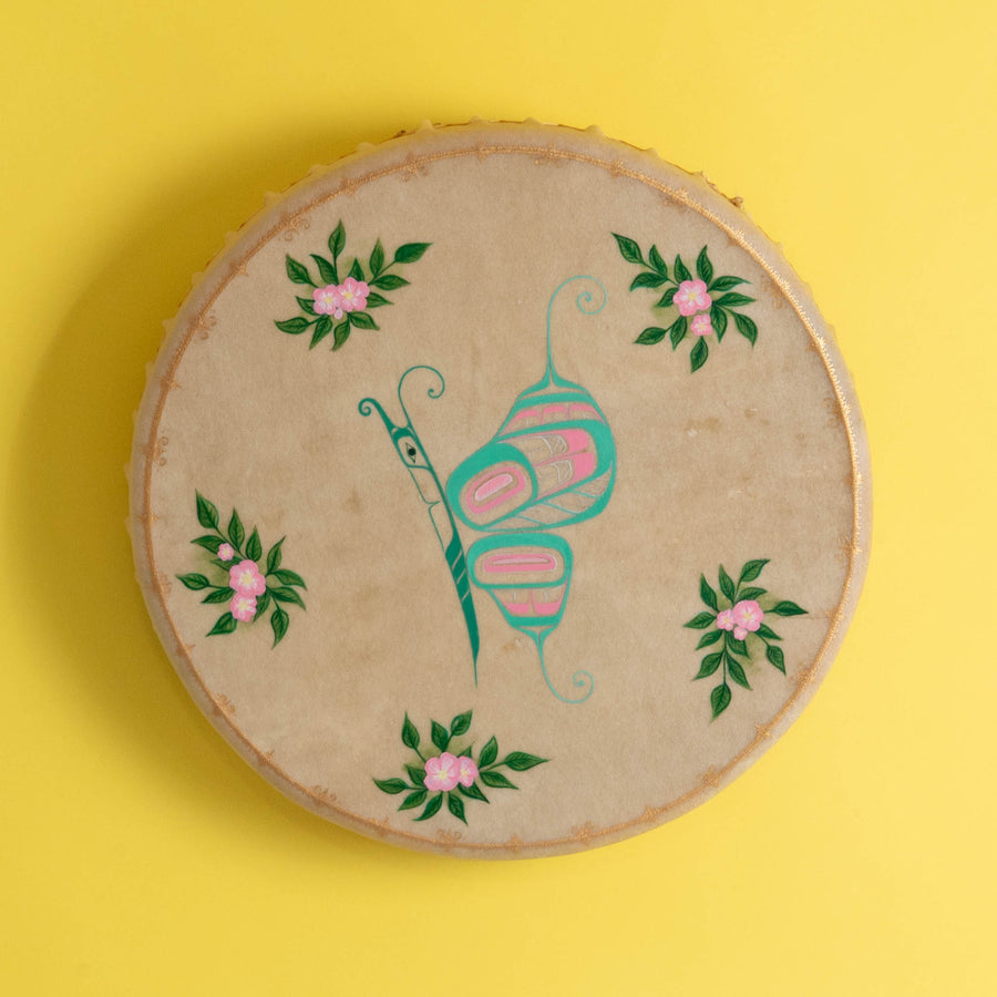 Butterfly Haida Art Drum by Danielle Louise Allard on a yellow background.