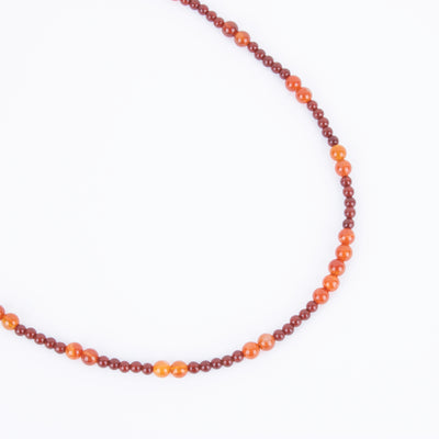 Photo showing of the necklace form of a Hand beaded deep red and orange Carnelian Agate Necklace with  sterling silver clasp