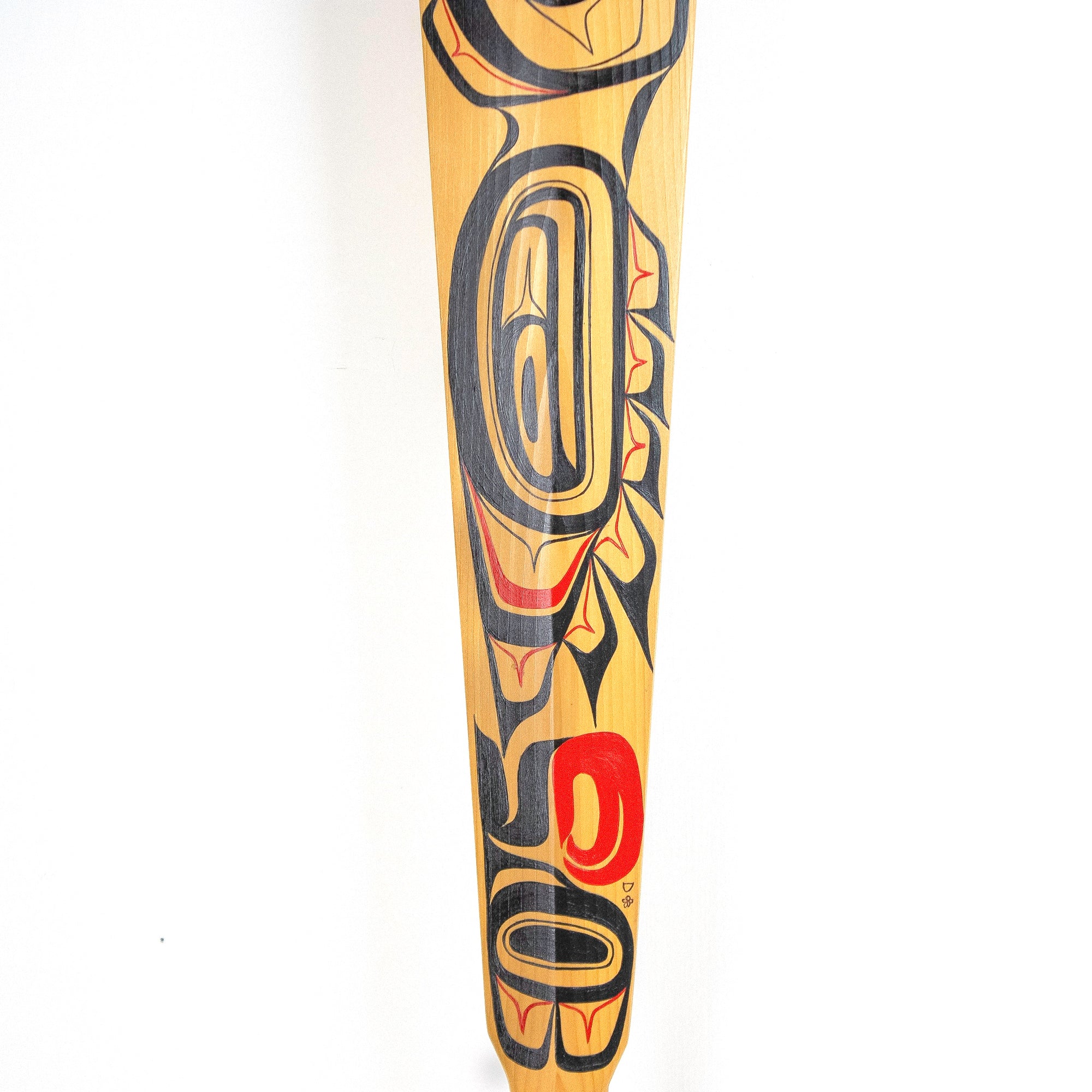 Close-up of painted wood paddle with northwest coast formline design