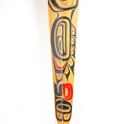 Close-up of painted wood paddle with northwest coast formline design