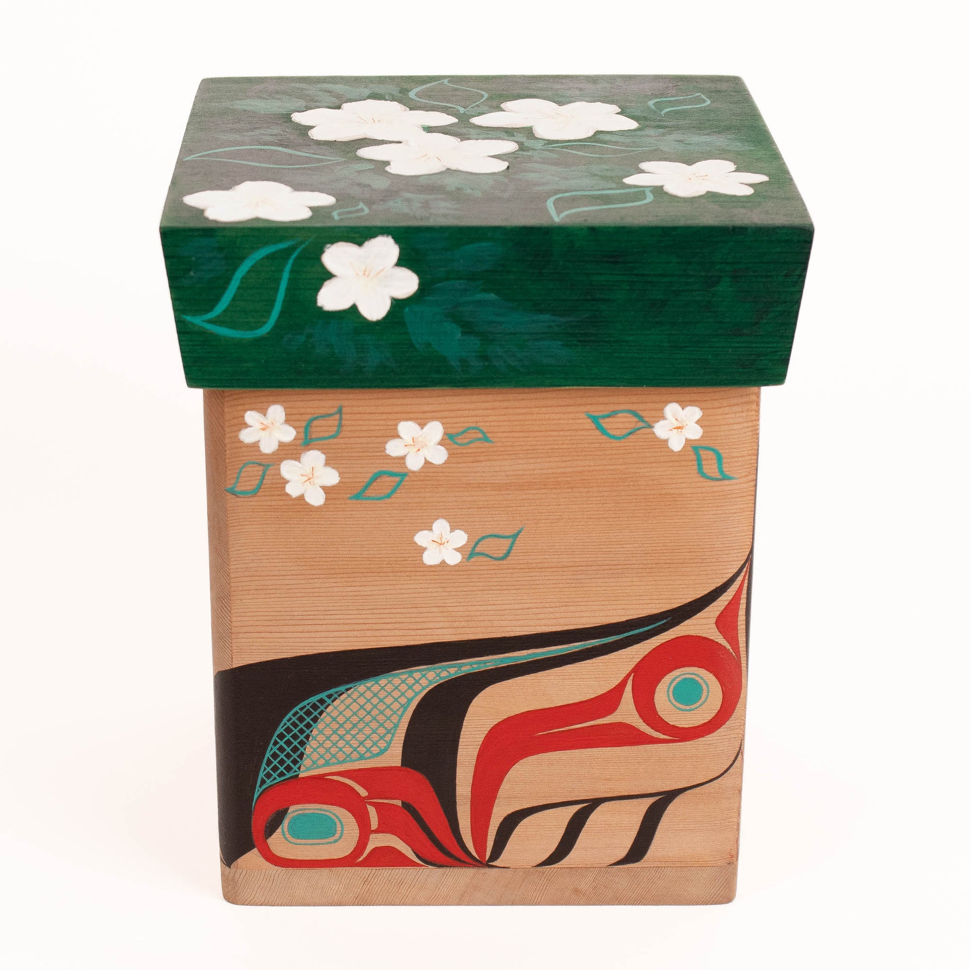 Wooden box with floral design on top and abstract carvings on the sides