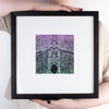 Haida fine art print in a sleek modern black frame held by model for size ratio, and to show of the sunning whimsical art design