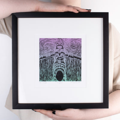 Haida fine art print in a sleek modern black frame held by model for size ratio, and to show of the sunning whimsical art design