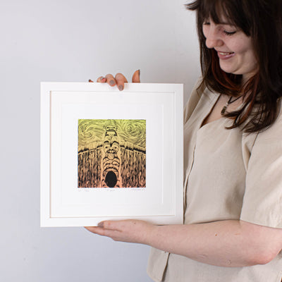 Haida Gwaii fine art print featuring a totem pole in front of a long house, the entrance of the longhouse is at the ottom of the pole with a bear around it, then a beaver and a watchmen