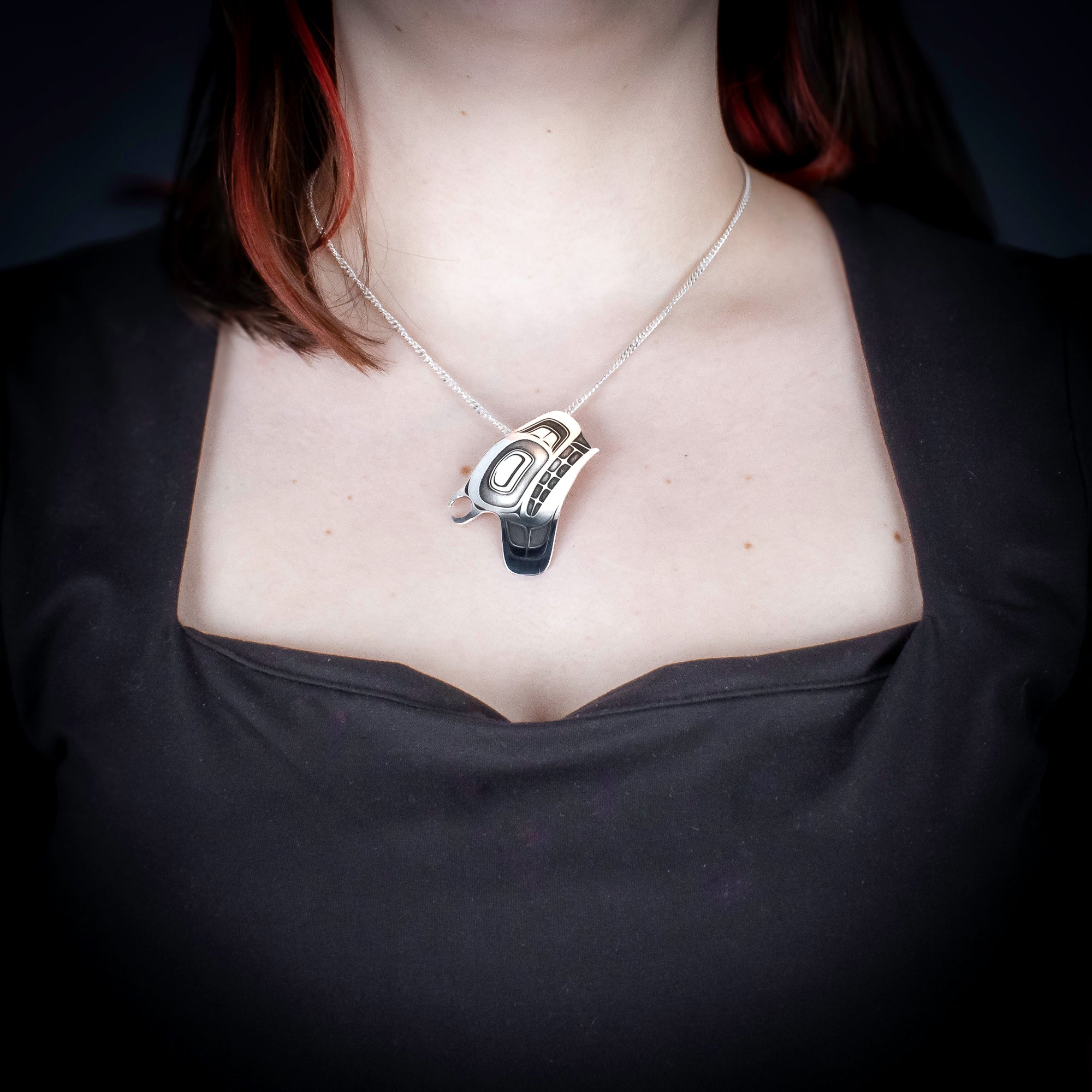 Sterling Silver orca/ Killer whale Pendant by Canadian Handpoke tattoo artist Danika worn by a model