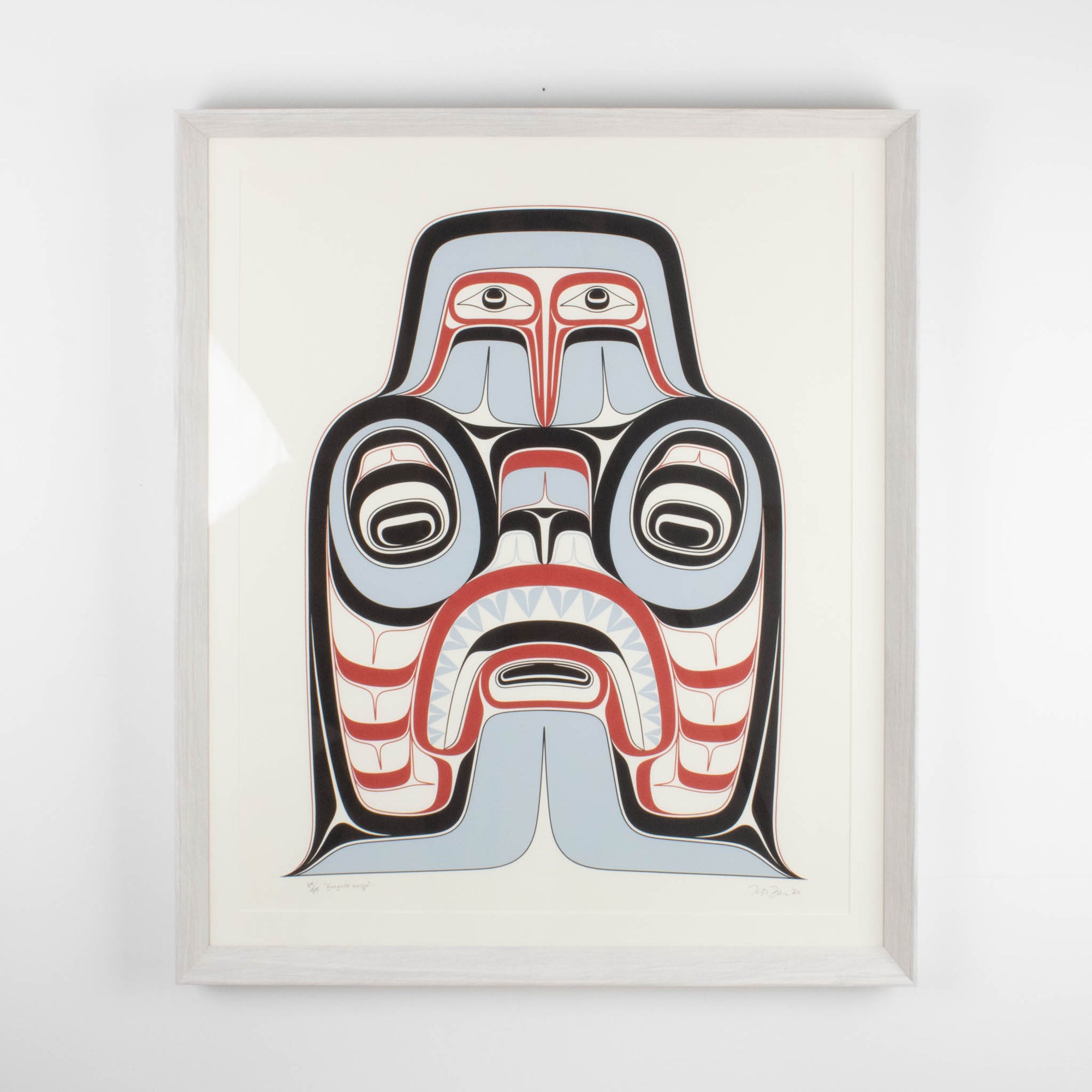 Haida Art print featuring supernatural being Dogfish mother. with bold red and black, and soft blue hues to show contrast, framed in a driftwood was frame