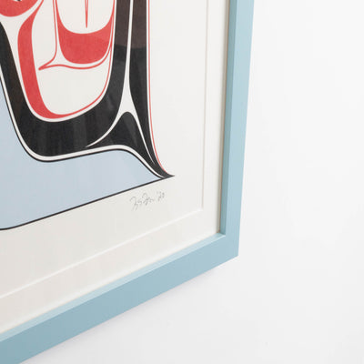Haida Art print featuring supernatural being Dogfish mother. with bold red and black, and soft blue hues to show contrast, framed in a driftwood was frame