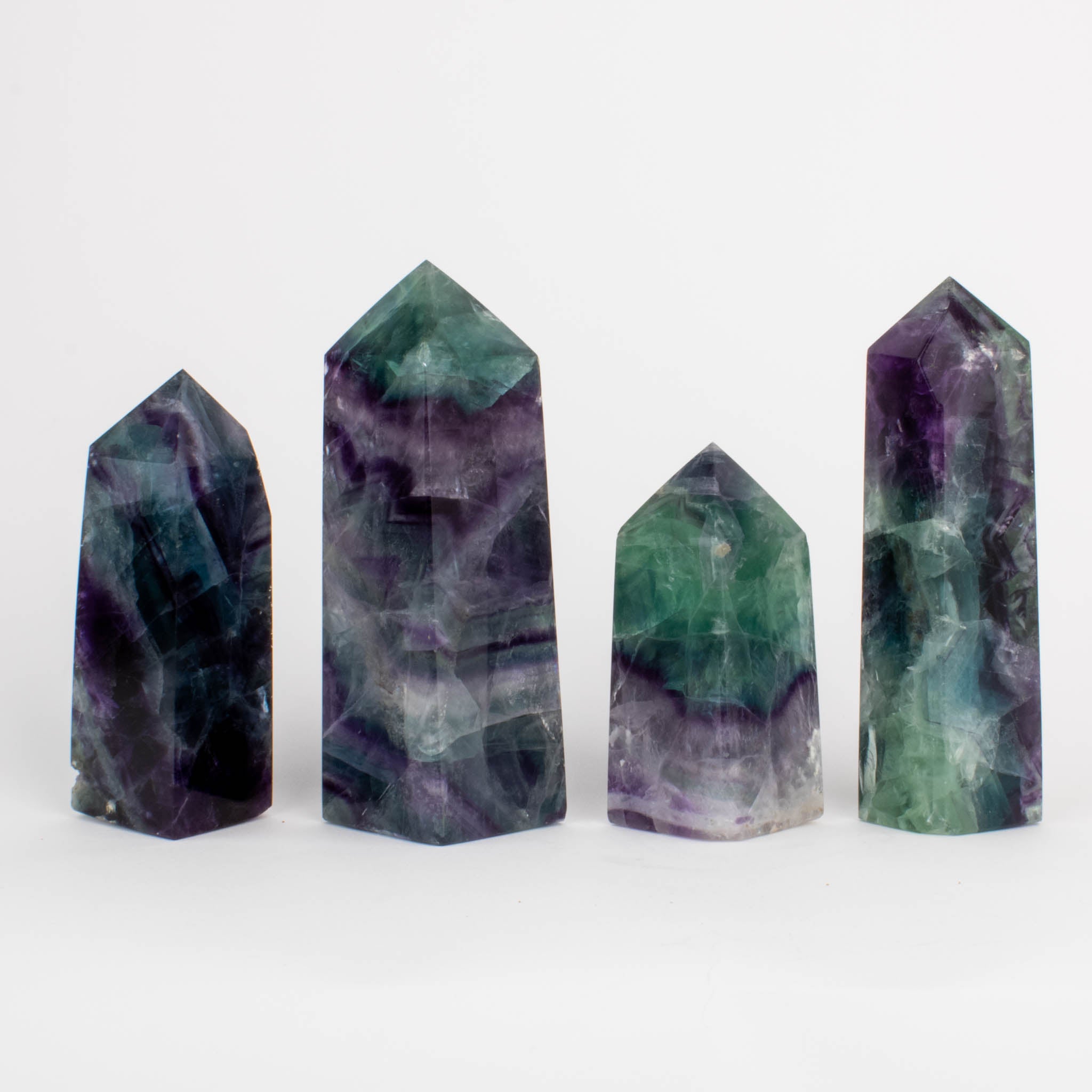 Four fluorite crystals lined up in a row. 