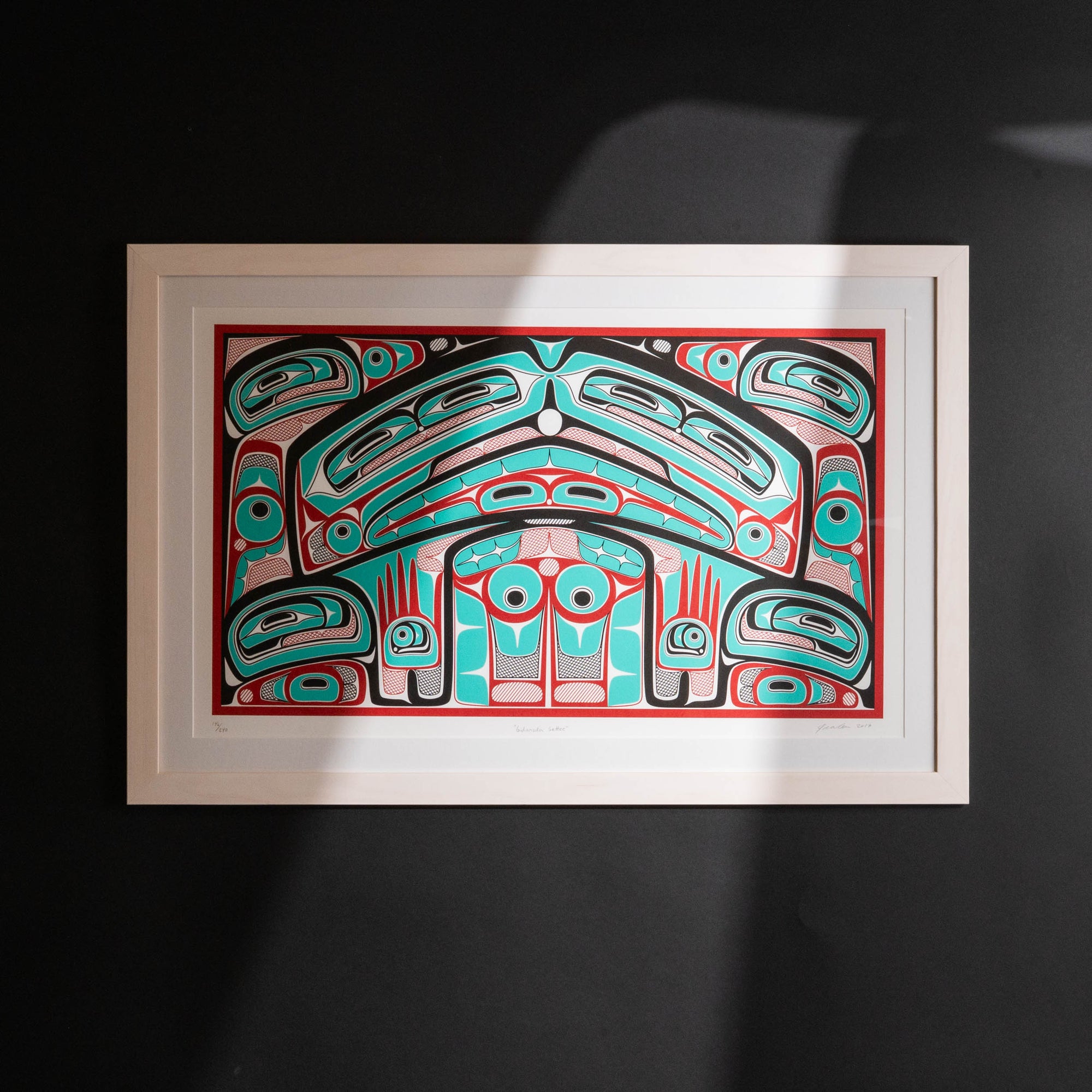 Colorful abstract formline chiefs chair design with geometric haida patterns  framed on a dark background