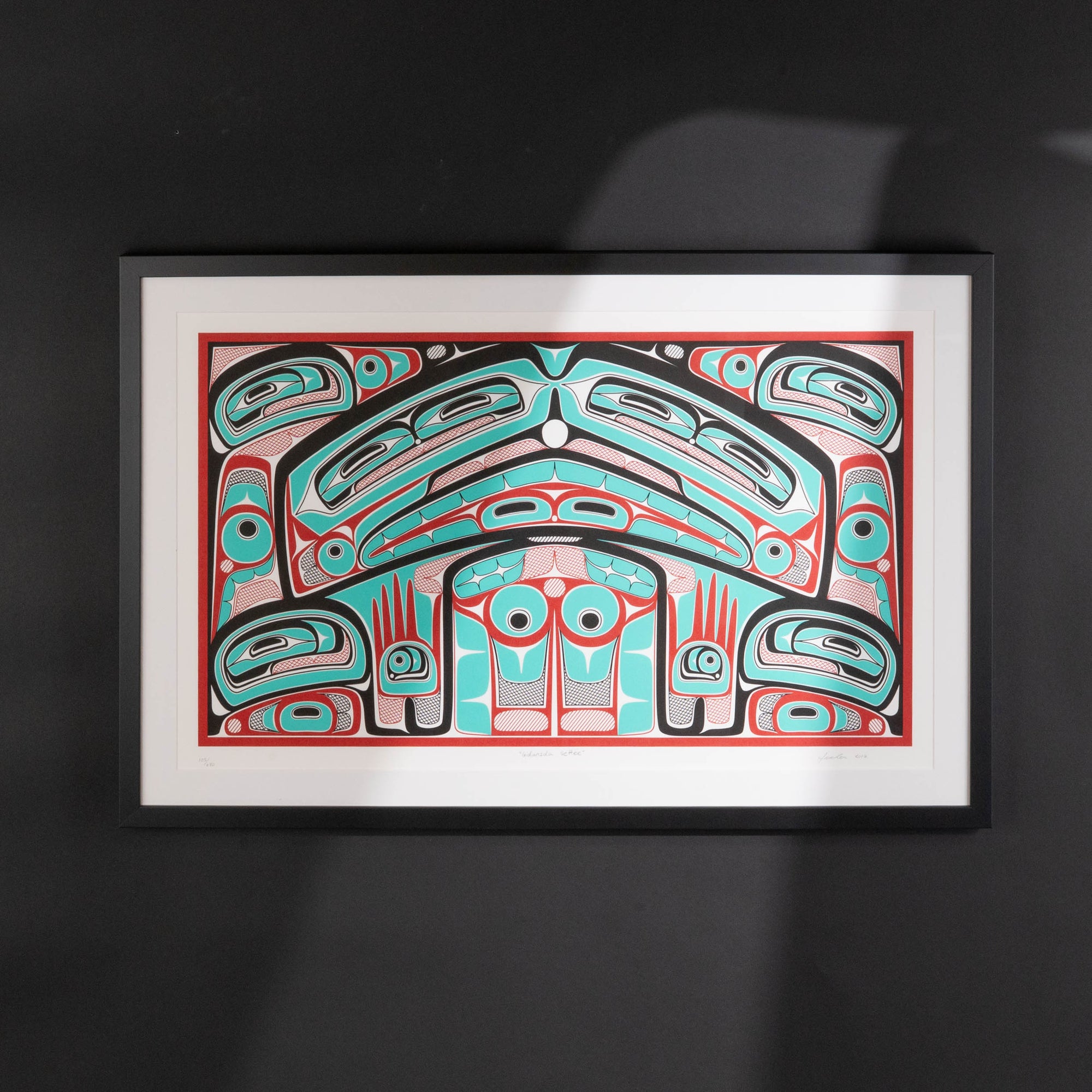 Colorful abstract formline chiefs chair design with geometric haida patterns  framed on a b;lack background