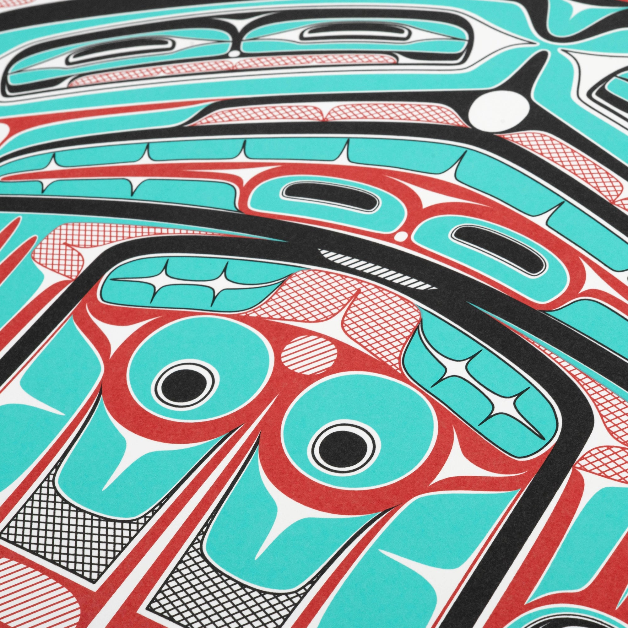 Close-up of a colorful abstract design with turquoise, red, and black colors.