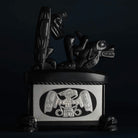 Haida argillite killer whale and thunderbird argillite and sterling silver box done by Haida artist Ding Hutchingson on a dark background