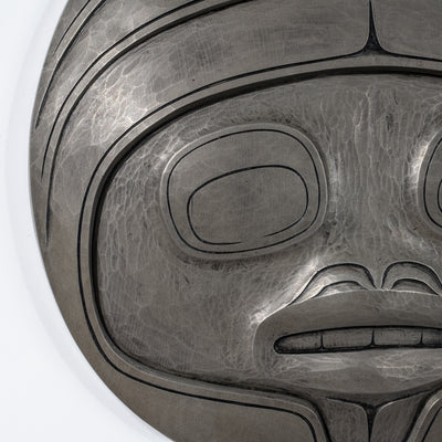 Close-up of a metallic looking Fungus Man Mask Casting mask with intricate designs by Haida artist Cori Savard on a white back ground on a white background