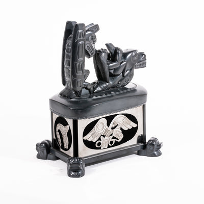 Haida argillite killer whale and thunderbird argillite and sterling silver box done by master Haida artist Ding Hutchingson on a white background showing the back and left side