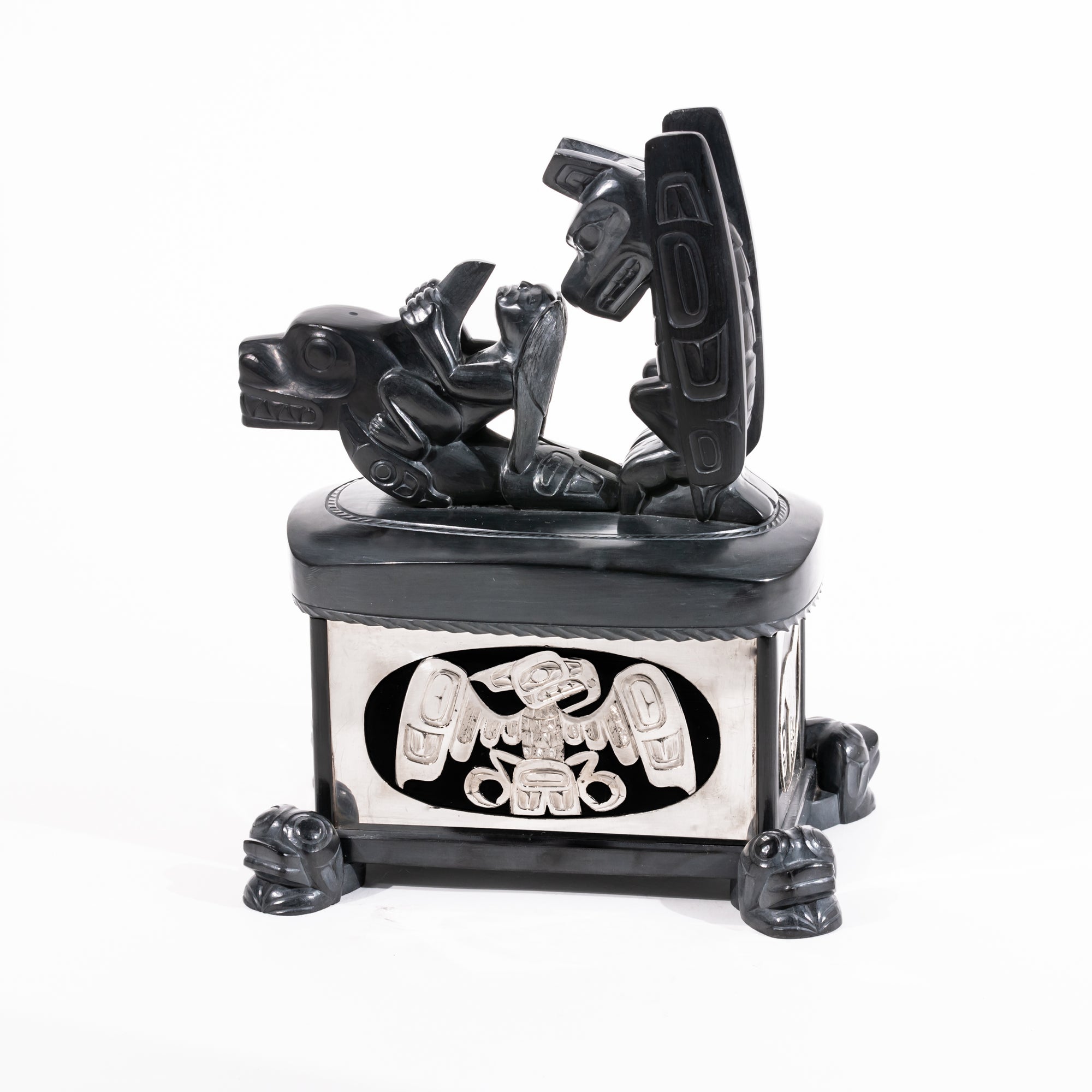 Haida argillite killer whale and thunderbird argillite and sterling silver box done by master Haida artist Ding Hutchingson on a white background showing the right side